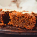 Slice of easy flourless oatmeal carrot cake with frosting on a plate